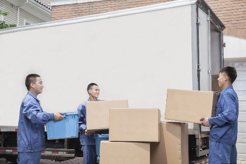 House removalists in Greenwich loading moving boxes into a van