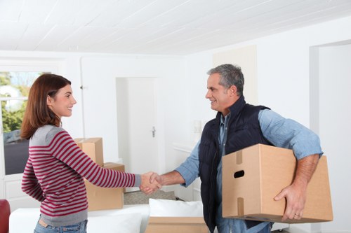 Movers handling desks and furniture during a Greenwich office move