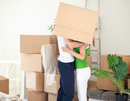 Careful manual handling of a box during a house move