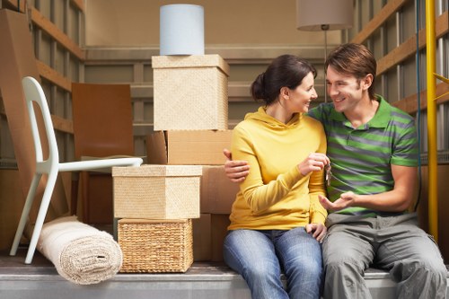 Professional movers packing household items carefully